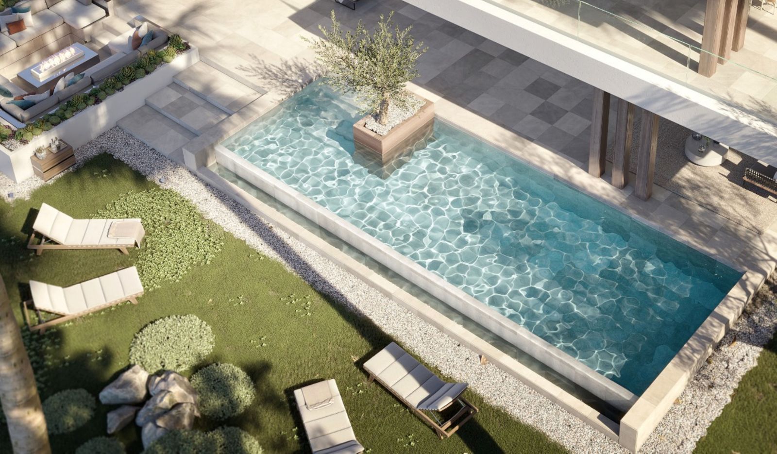 Aerial view of a modern poolside area with lounge chairs, greenery, and a patio.