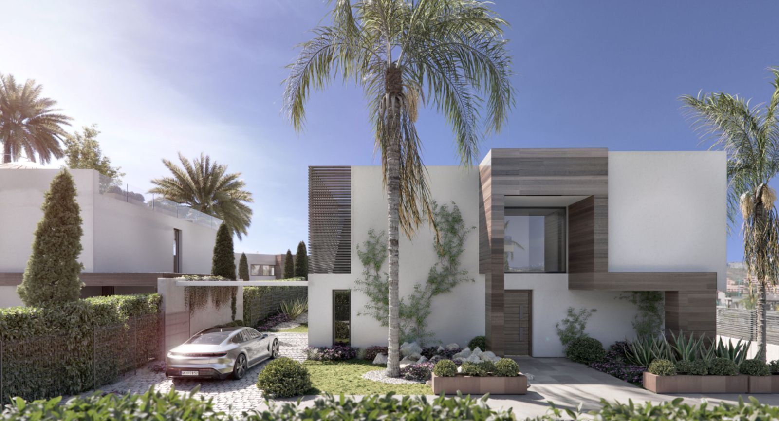 Modern two-story house with palm trees, driveway, and mountain view.